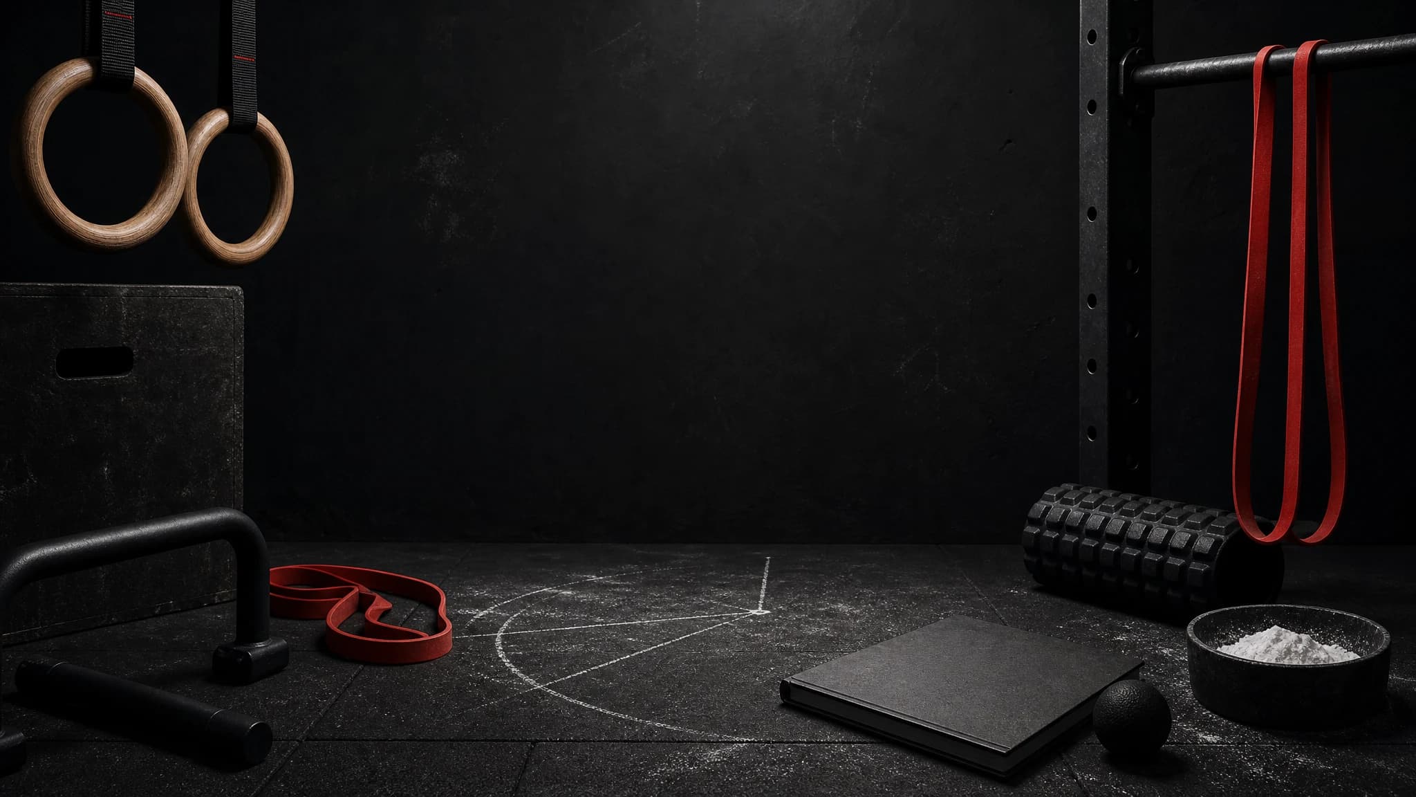 Dark rings, bar, resistance band, and chalk marks for calisthenics and mobility.